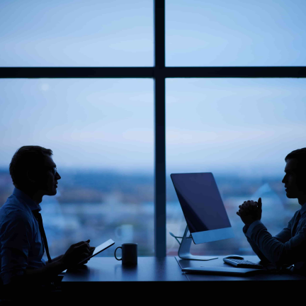 Two people chatting in an office