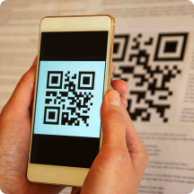 Hand holding a phone with a QR